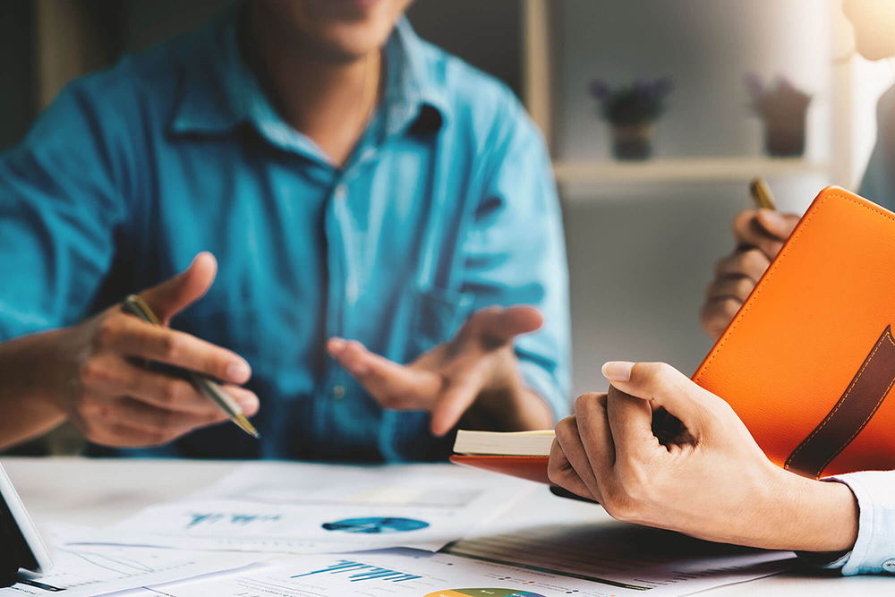 Advisor discussing plan of investment of financial report to client